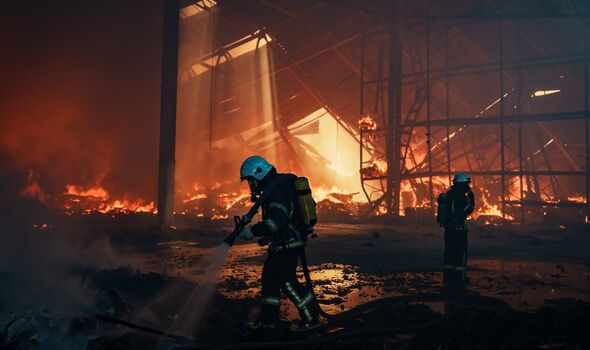 Firefighters work to put out a fire at CHP power station hit by Russian missil