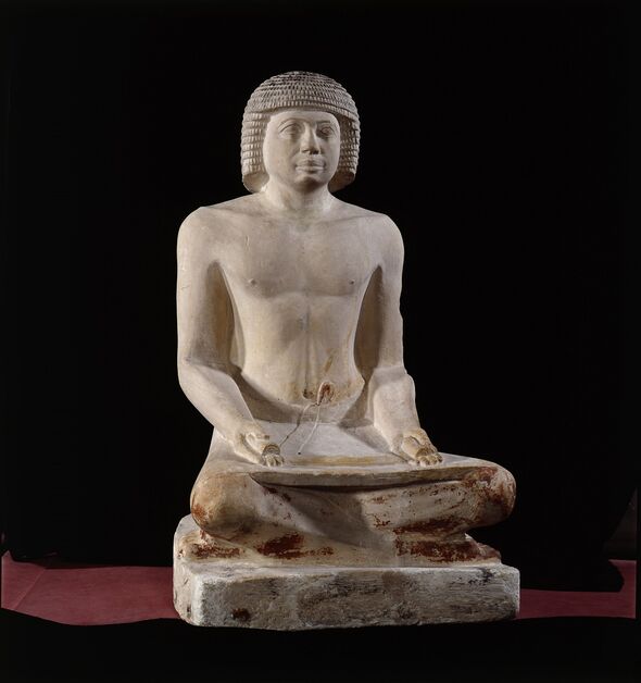 A statue of an ancient Egyptian scribe